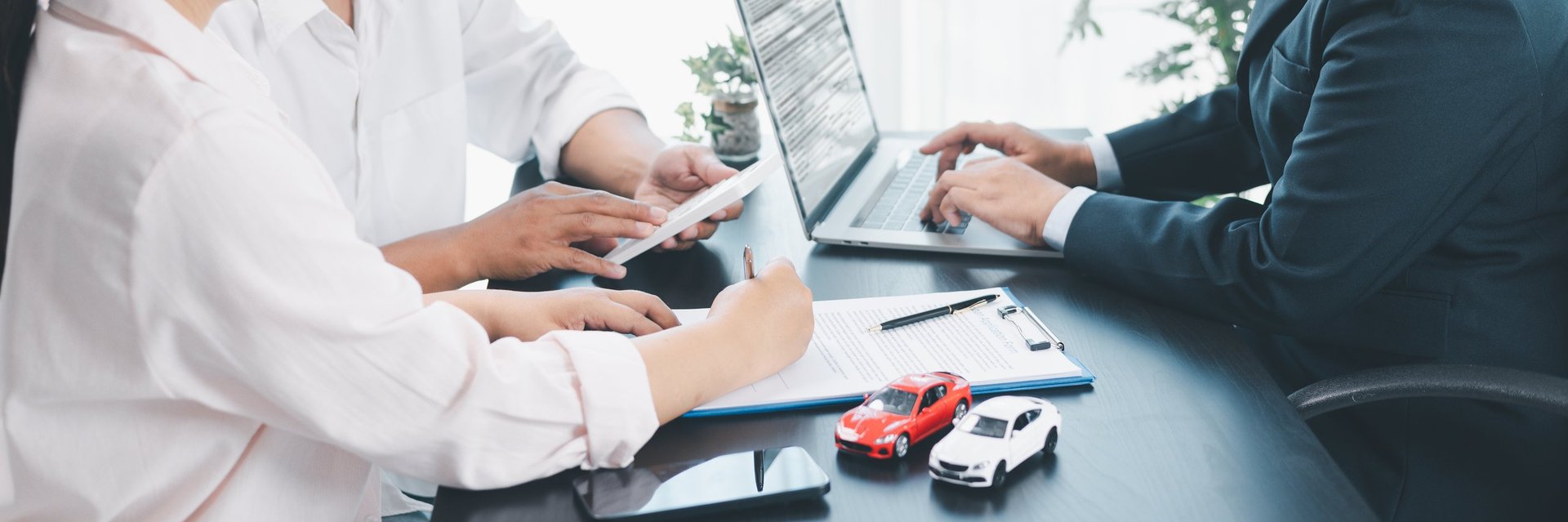 Car loan agreement signing with dealer